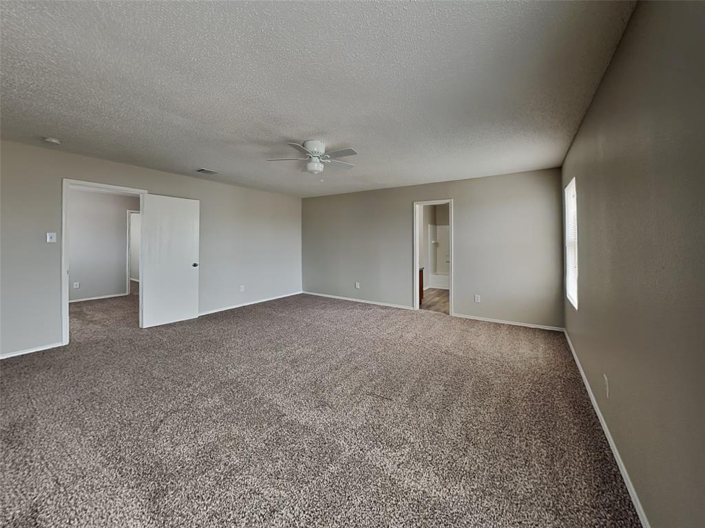 216 Turning Tree Road Wilmer, TX 75172 - Photo 8 of 20 Spare room featuring carpet floors, a textured ceiling, and ceiling fan