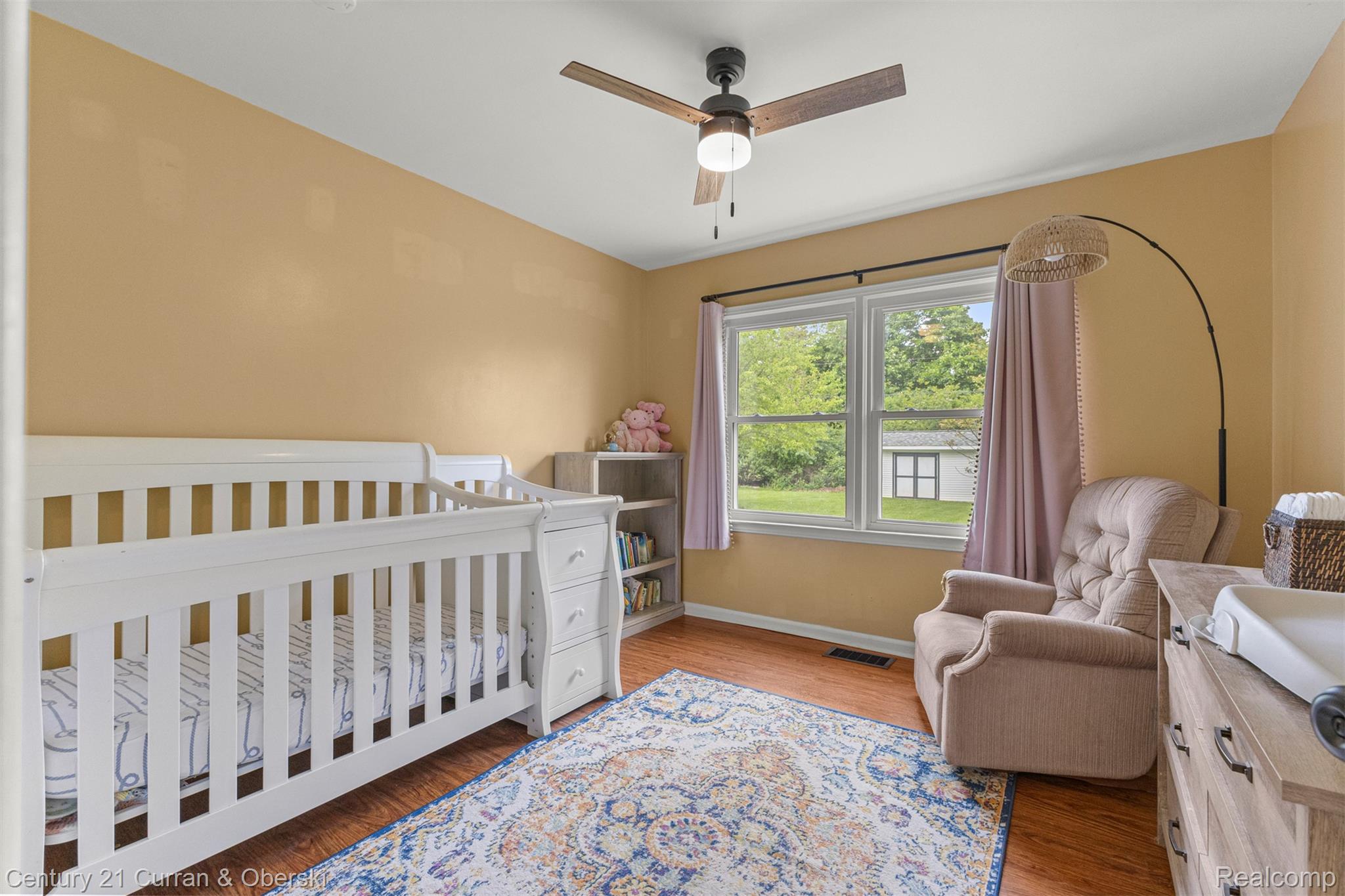 411 South Adrian Street Tecumseh, MI 49286 - Photo 27 of 61 Bedroom with a nursery area, light wood finished floors, and ceiling fan
