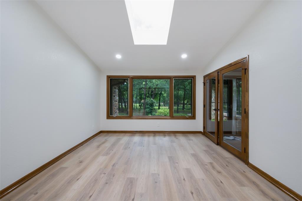 1607 North Main Street Euless, TX 76039 - Photo 23 of 39 wooden floor in an empty room with a window