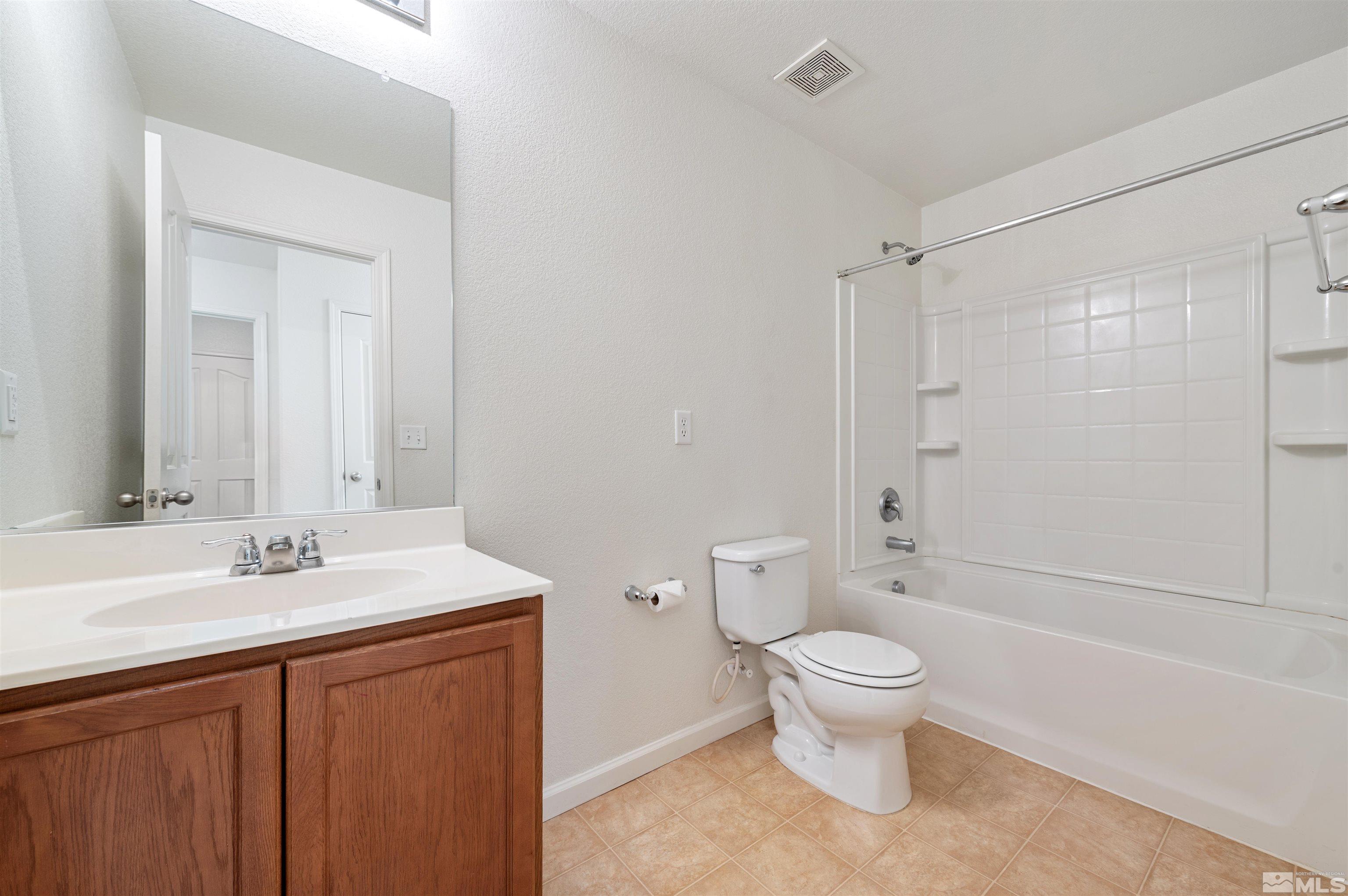 11360 Verazae Drive Reno, NV 89521 - Photo 15 of 22 a bathroom with a sink a toilet and shower