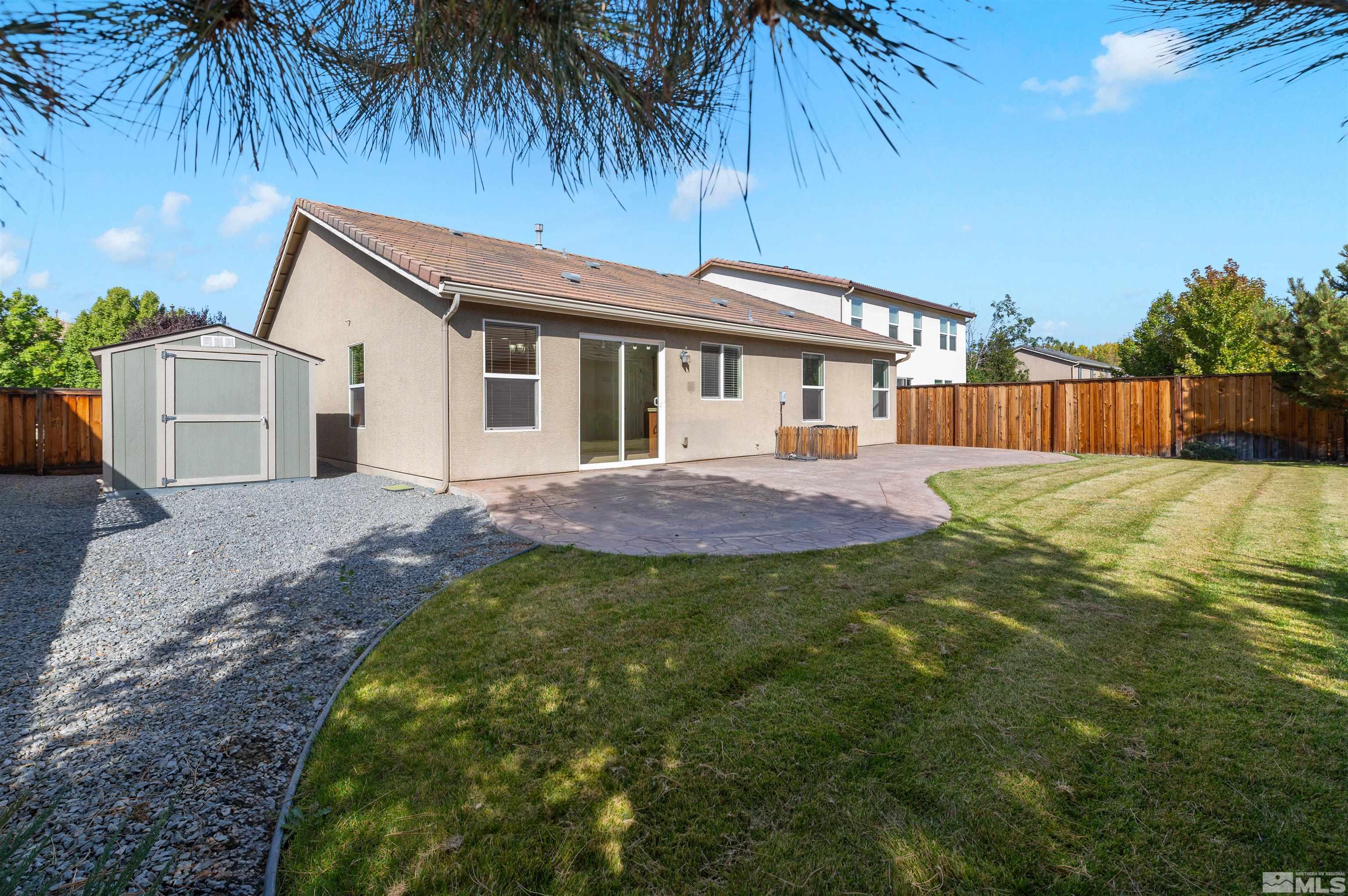 11360 Verazae Drive Reno, NV 89521 - Photo 19 of 22 a view of backyard with a garden and palm trees