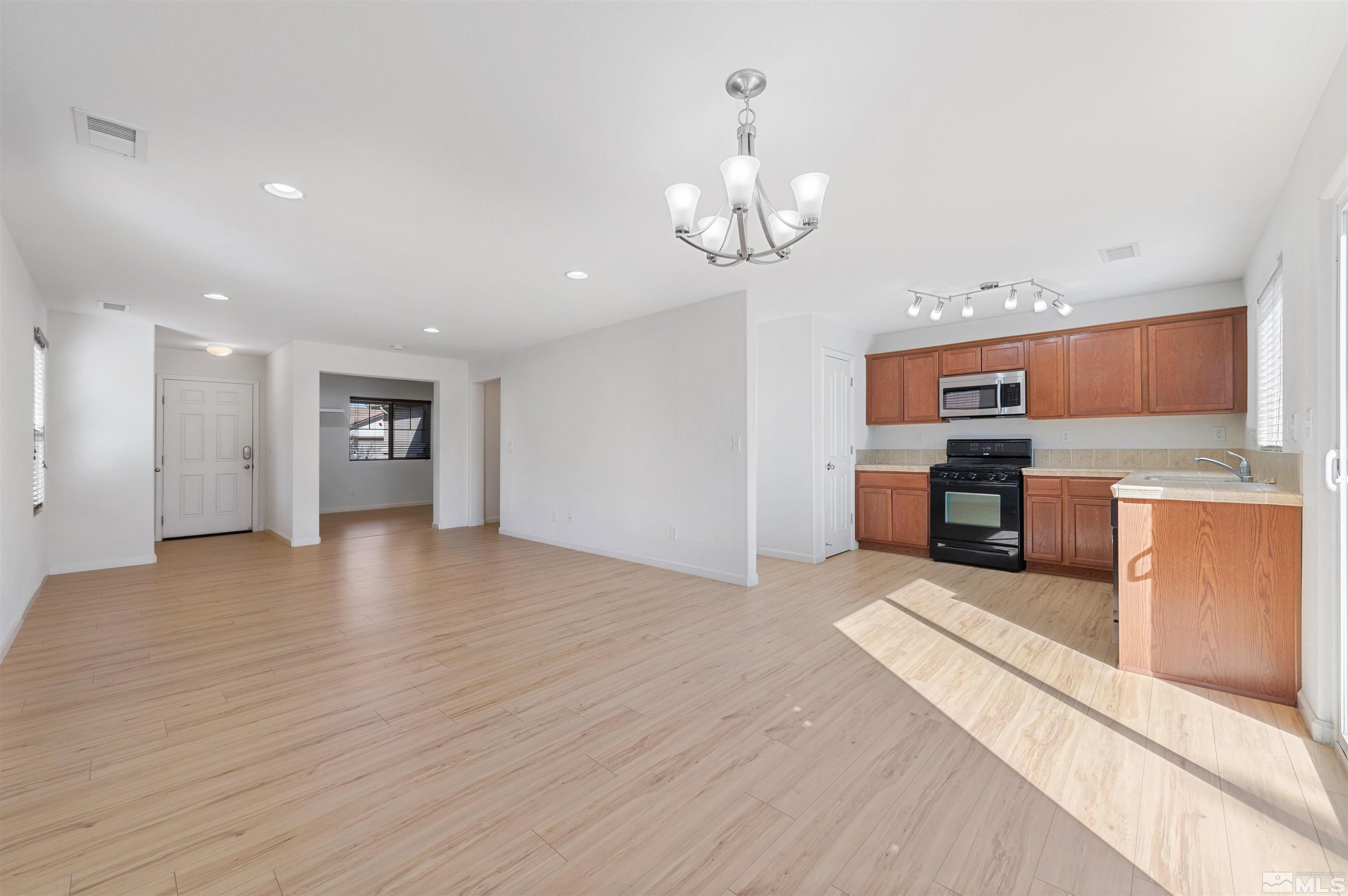 11360 Verazae Drive Reno, NV 89521 - Photo 4 of 22 a view of a kitchen with a sink and stainless steel appliances