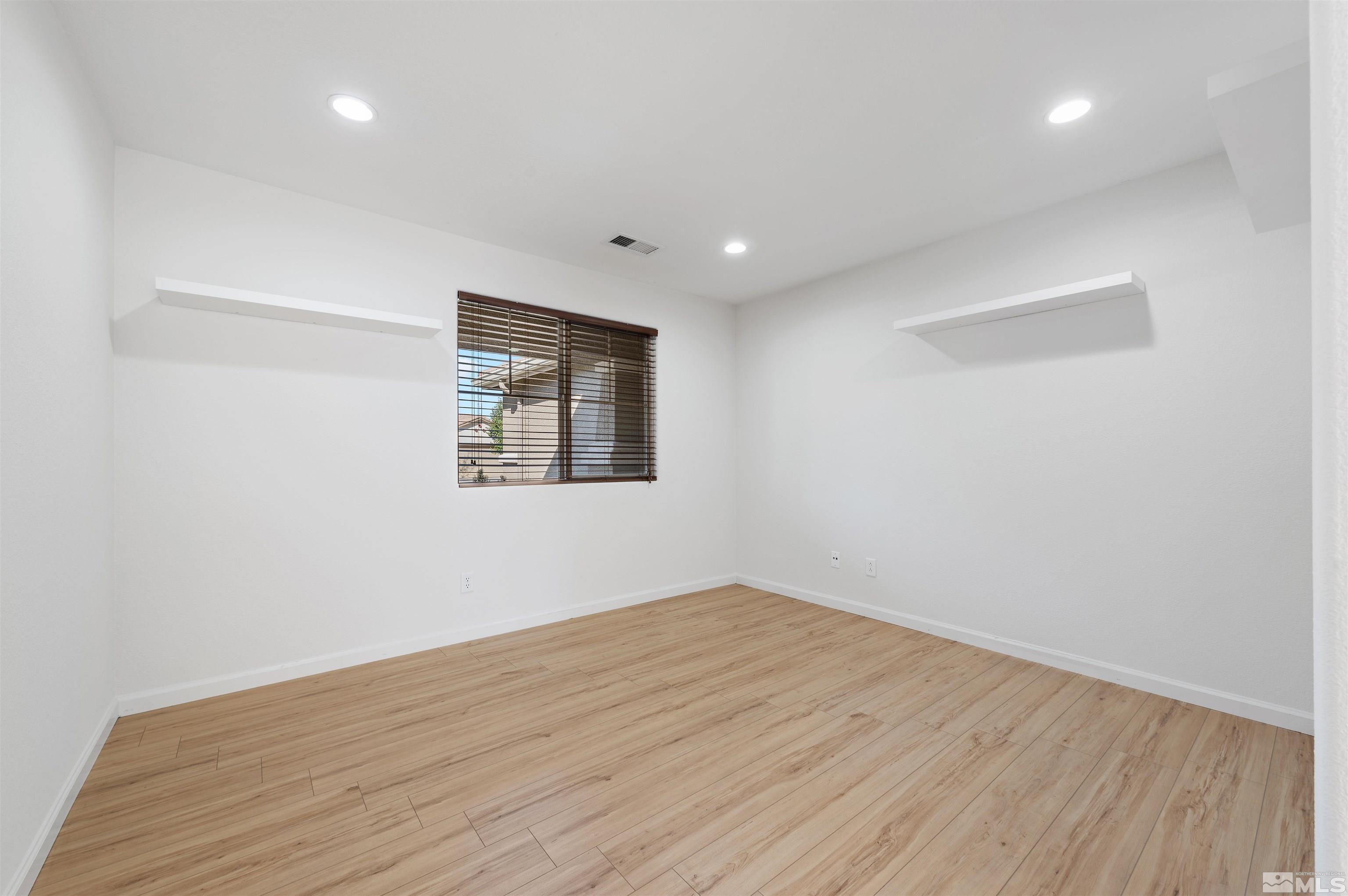 11360 Verazae Drive Reno, NV 89521 - Photo 7 of 22 a view of empty room with wooden floor