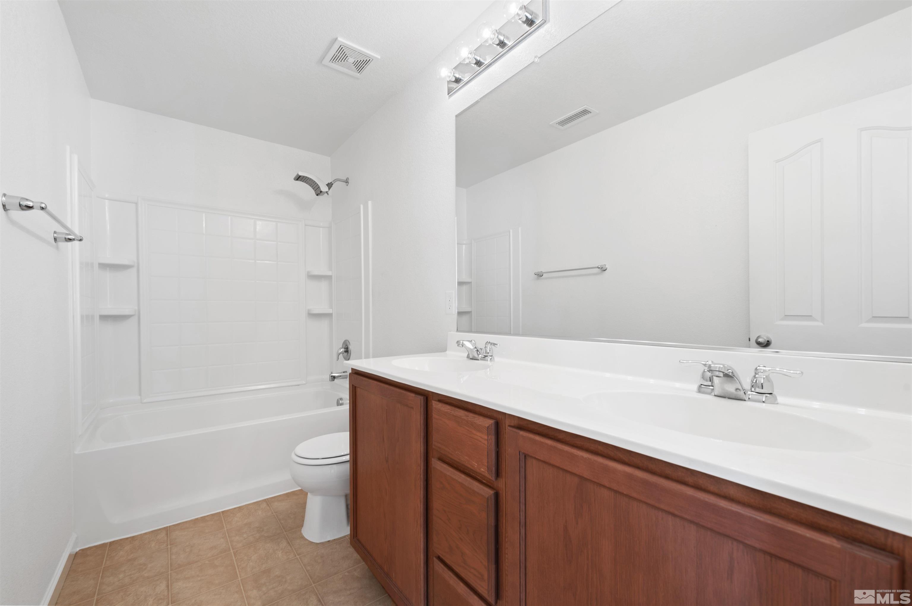 11360 Verazae Drive Reno, NV 89521 - Photo 10 of 22 a bathroom with a sink a toilet and shower
