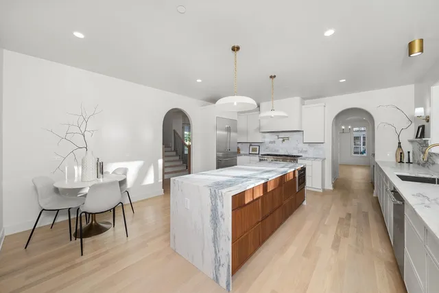 a kitchen with granite countertop a stove and a refrigerator