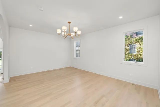 a view of a chandelier fan and wooden floor