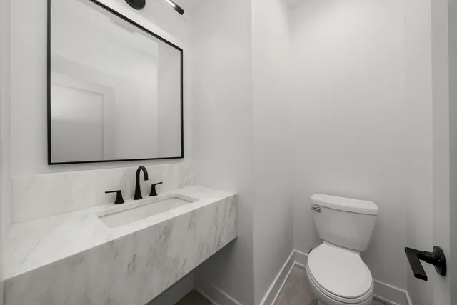a bathroom with a toilet sink shower and mirror