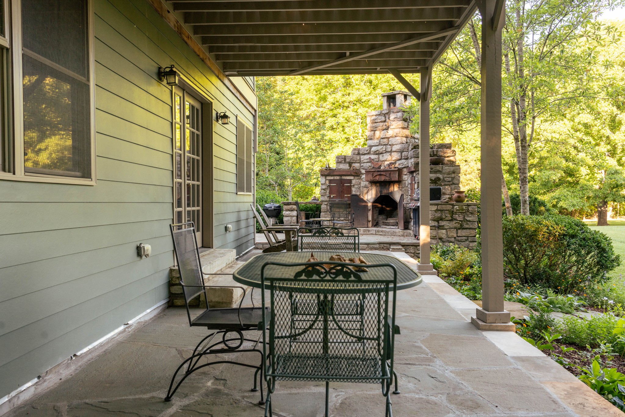 1098 Fred Gibbs Road White Bluff, TN 37187 - Photo 38 of 72 a patio with table and chairs and potted plants