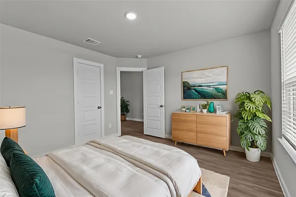 a room with a bed and a dresser