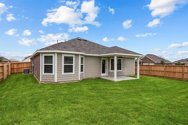 a view of a house with a yard and sitting area