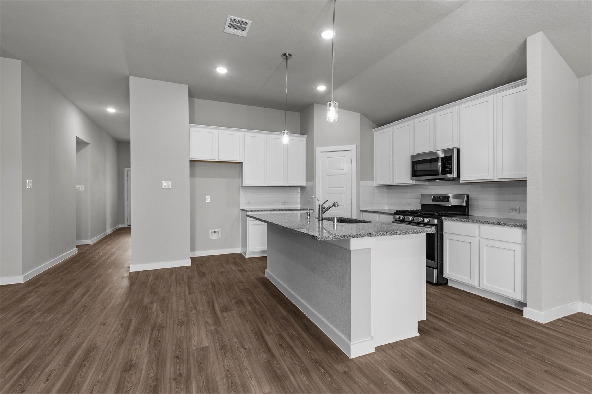 3003 Middleton Drive Rosenberg, TX 77471 - Photo 3 of 18 a kitchen with granite countertop a sink cabinets and stainless steel appliances