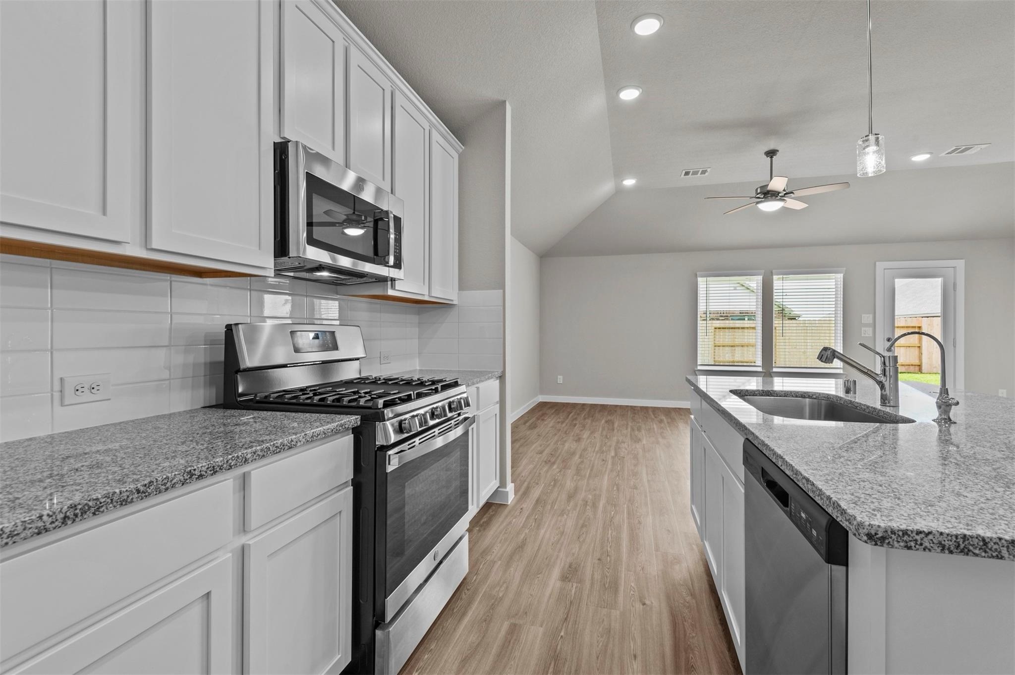 3003 Middleton Drive Rosenberg, TX 77471 - Photo 5 of 18 a kitchen with stainless steel appliances granite countertop a sink stove and cabinets