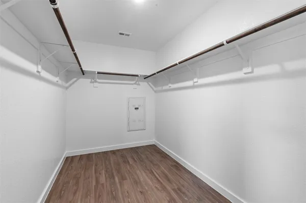 a view of a room with wooden floor