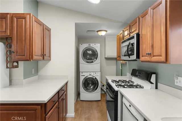 a kitchen with kitchen island a stove a sink and a refrigerator with wooden cabinets