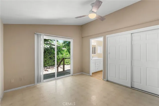 an empty room with windows and closet