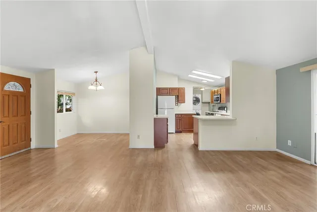 a view of a kitchen and an empty room