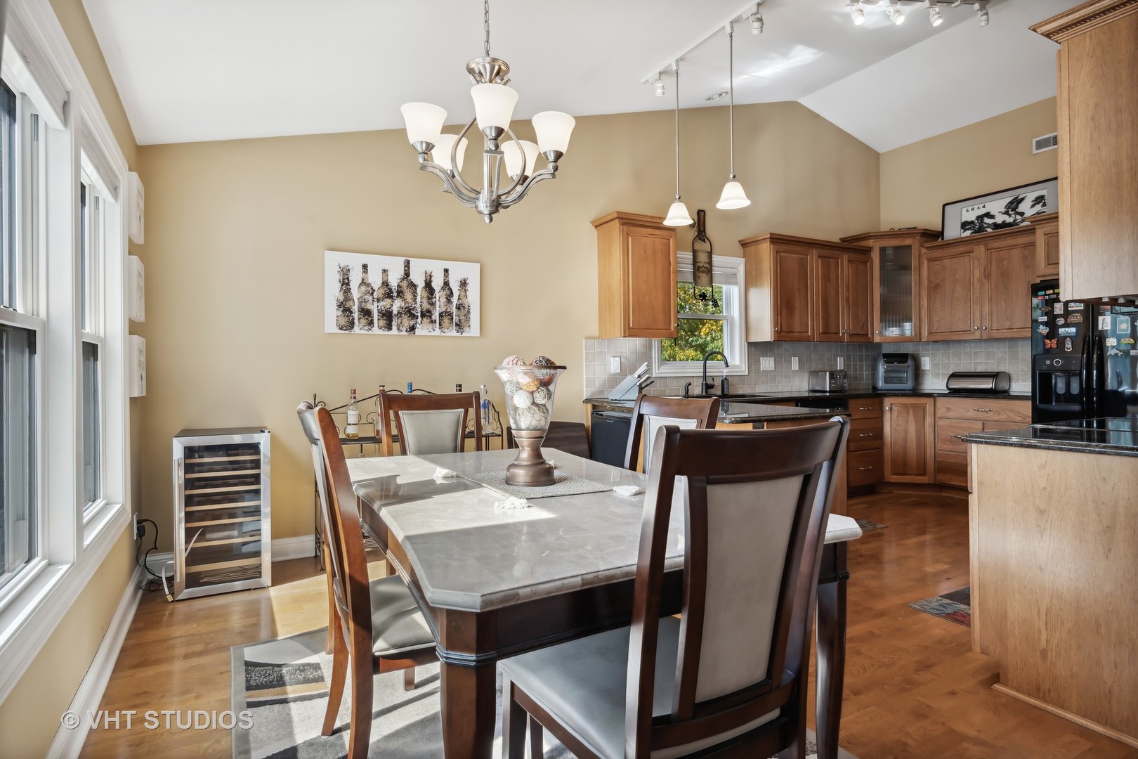 318 Ridge Road, Unit 318 North Aurora, IL 60542 - Photo 6 of 13 a view of a dining room with furniture a chandelier and wooden floor
