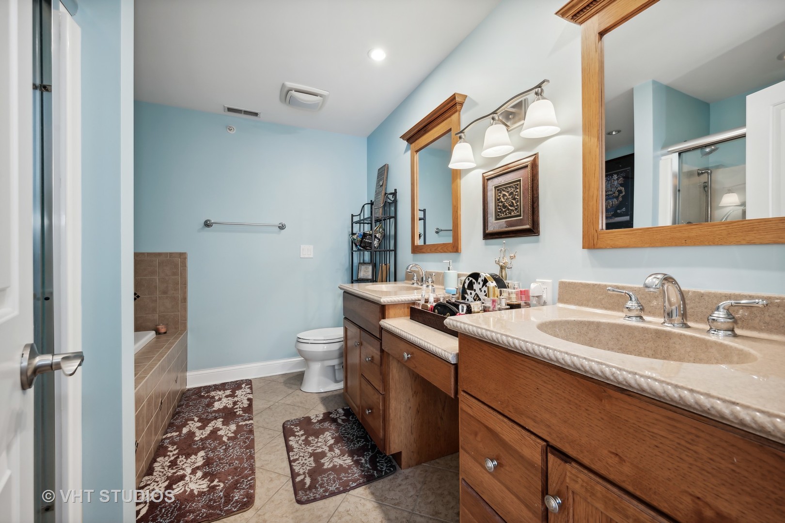 318 Ridge Road, Unit 318 North Aurora, IL 60542 - Photo 9 of 13 a bathroom with a sink a toilet and mirror