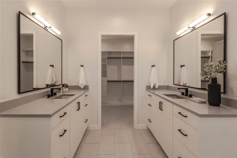a bathroom with a double vanity sink and mirror