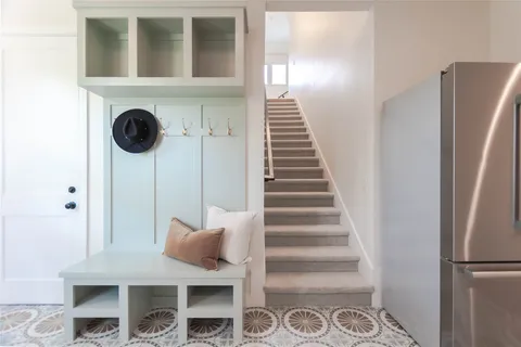 a view of entryway and hall with wooden floor
