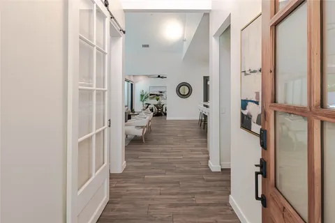a view of a hallway with wooden floor and staircase