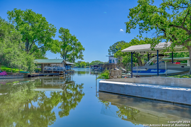 101 Princess Terrace Sunrise Beach, TX 78643 - Photo 12 of 17 a small pool with lawn chairs under an umbrella