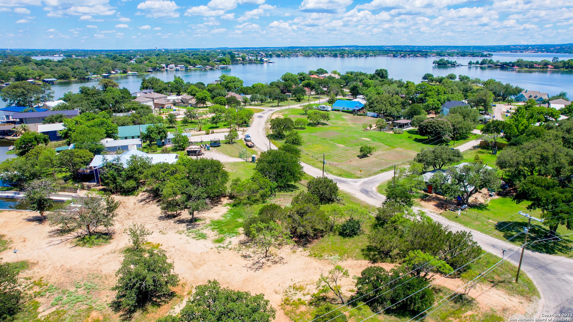 101 Princess Terrace Sunrise Beach, TX 78643 - Photo 6 of 17 a view of a lake with a building in the background