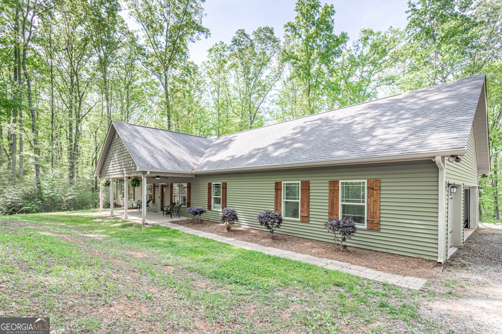 355 Boynton Road Hampton, GA 30228 - Photo 1 of 1 a backyard of a house with yard table and chairs
