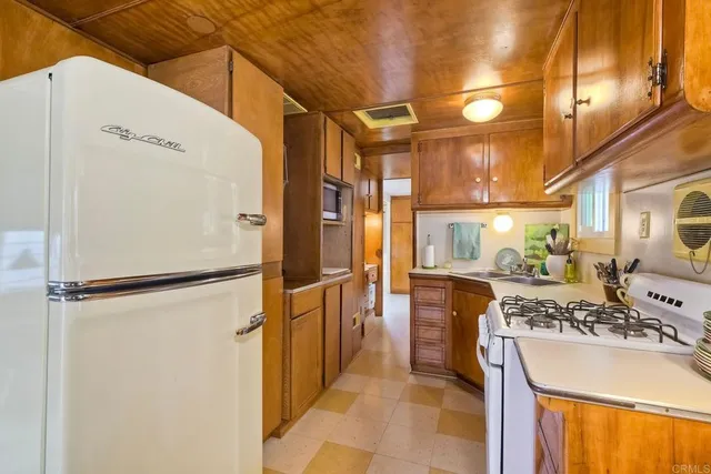 a kitchen with a refrigerator and a stove