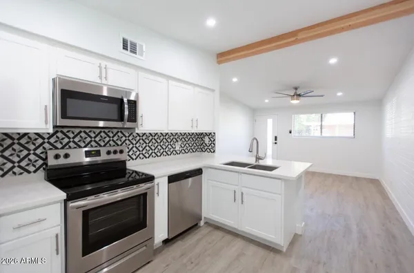 a kitchen with a sink and stove top oven