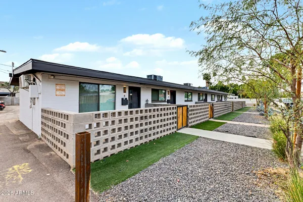 a view of house with backyard and trees