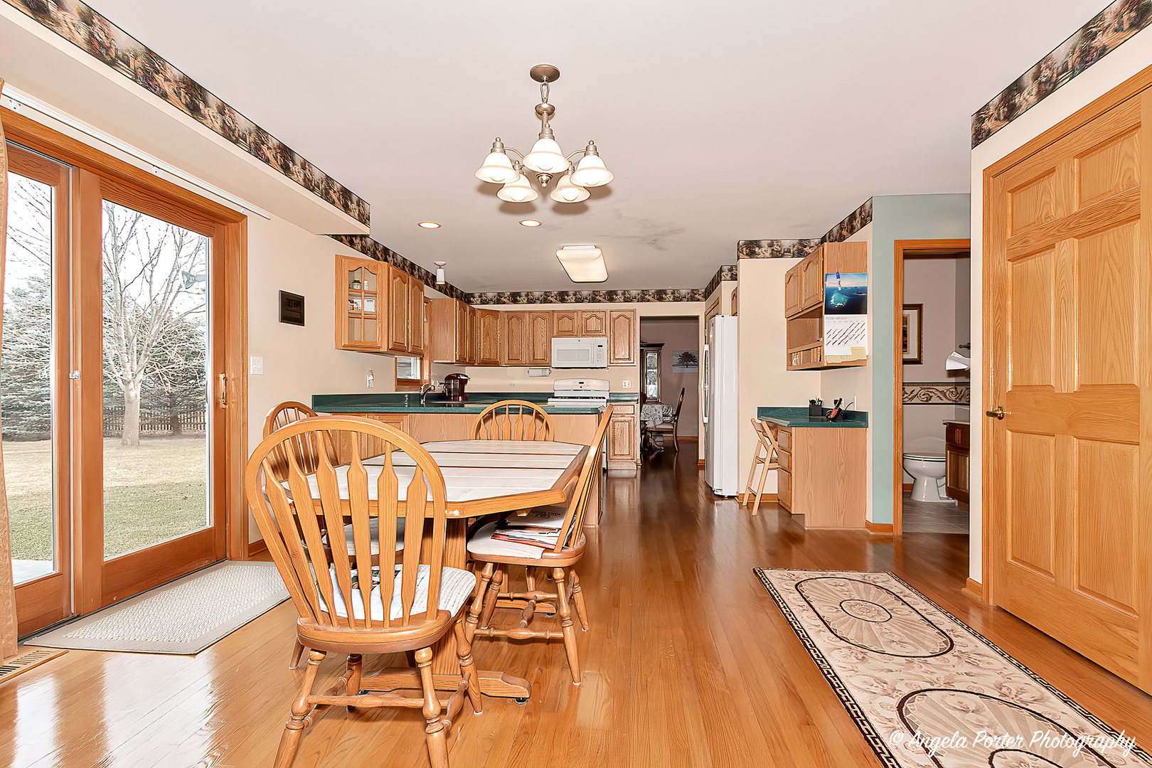 814 Suzanne Lane Spring Grove, IL 60081 - Photo 11 of 45 a dining room with furniture and wooden floor