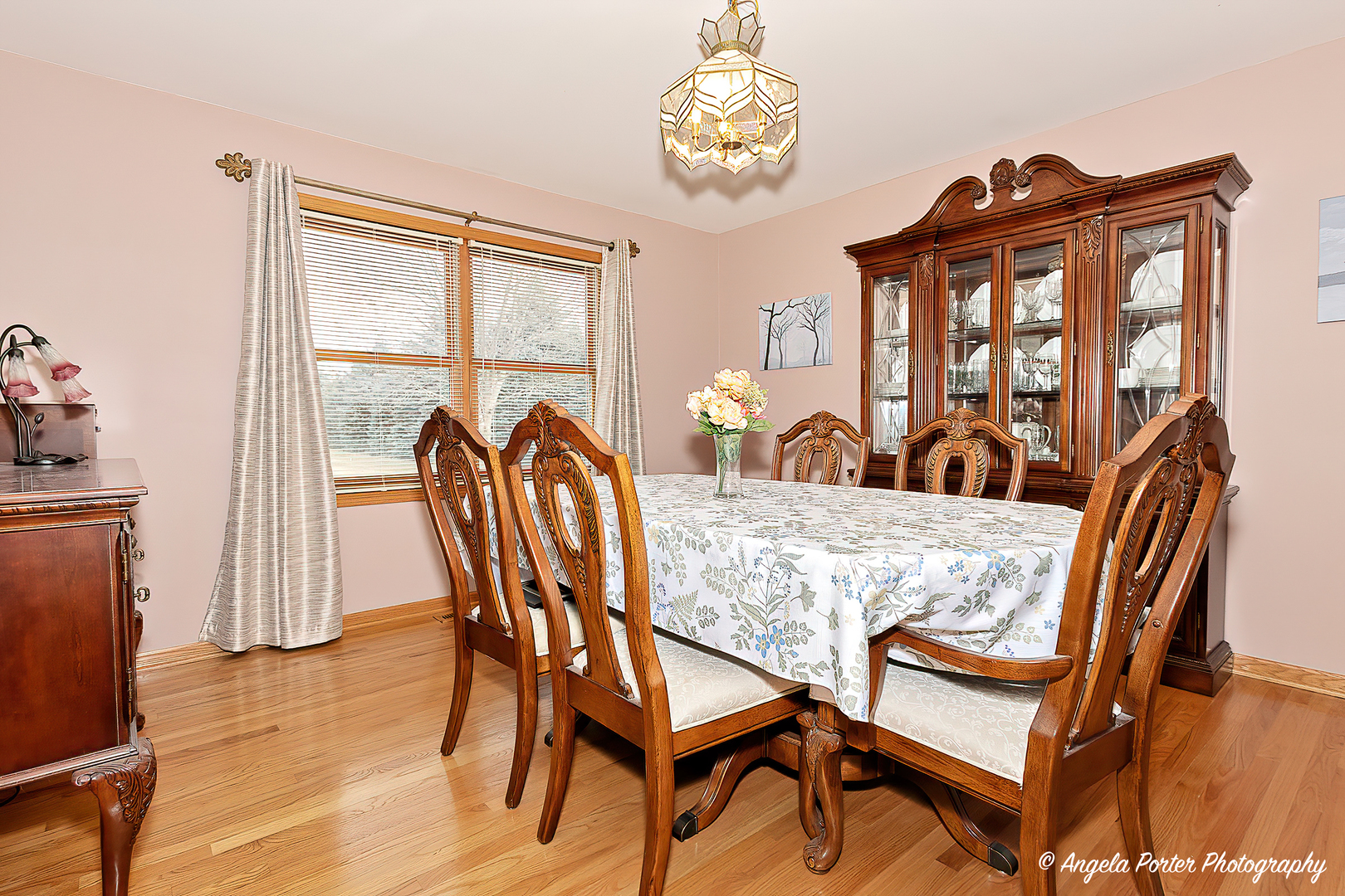 814 Suzanne Lane Spring Grove, IL 60081 - Photo 15 of 45 a view of a dining room with furniture a chandelier and wooden floor