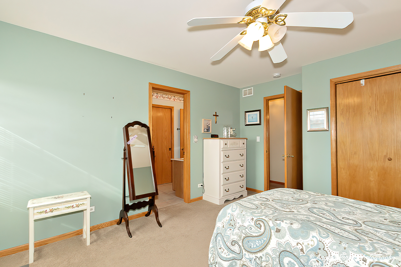 814 Suzanne Lane Spring Grove, IL 60081 - Photo 25 of 45 a bedroom with a bed and a chandelier