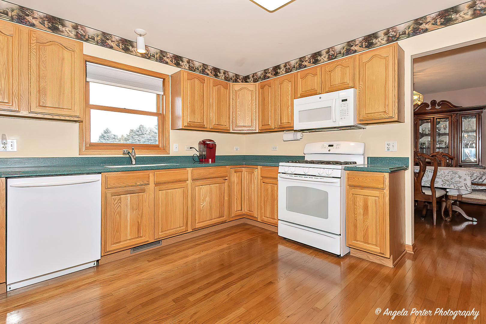 814 Suzanne Lane Spring Grove, IL 60081 - Photo 6 of 45 a kitchen with stainless steel appliances a white stove top oven cabinets and a wooden floor