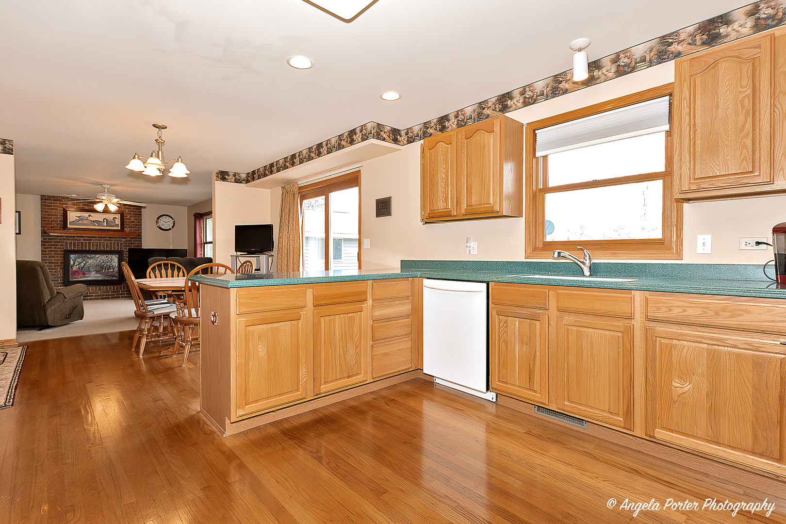 814 Suzanne Lane Spring Grove, IL 60081 - Photo 7 of 45 a large kitchen with cabinets a sink a window and stainless steel appliances