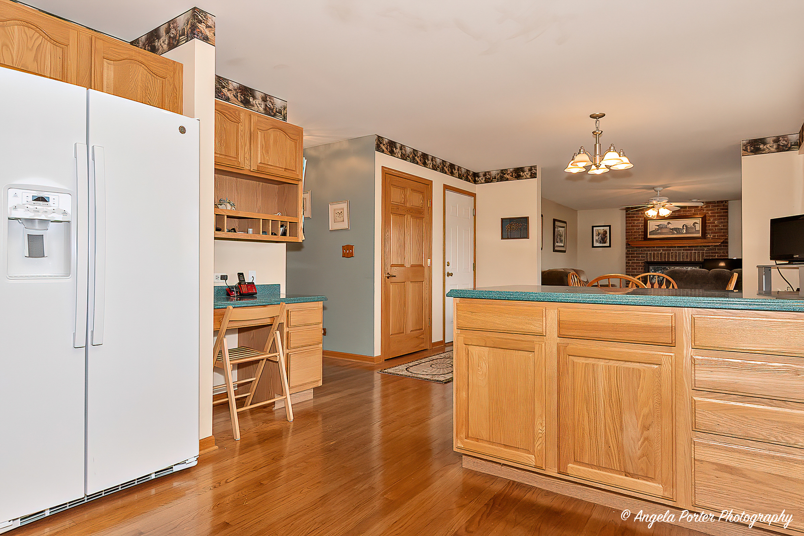 814 Suzanne Lane Spring Grove, IL 60081 - Photo 8 of 45 a large kitchen with a refrigerator a stove and a dining table with wooden floor