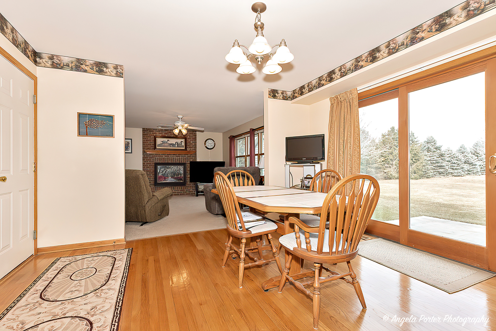 814 Suzanne Lane Spring Grove, IL 60081 - Photo 9 of 45 a view of a dining room with furniture a chandelier and wooden floor