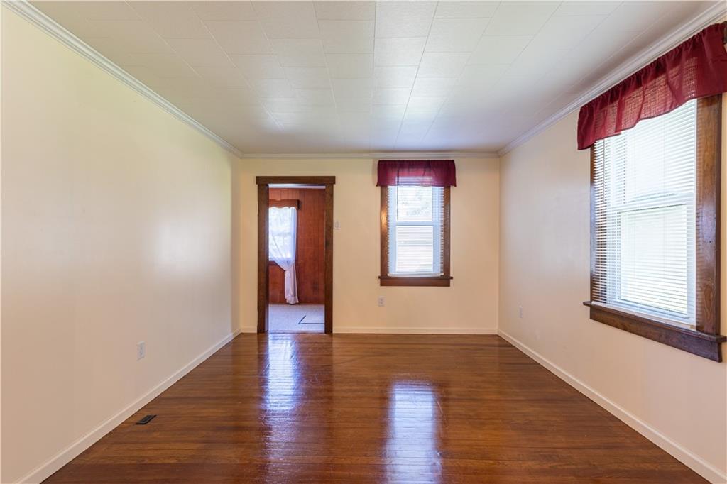 216 Carson Road Dawson, PA 15428 - Photo 6 of 25 a view of an empty room with wooden floor and a window