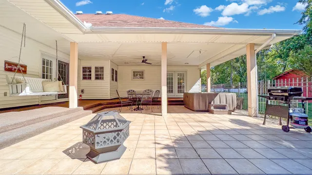 a view of a patio with table and chairs and potted plants