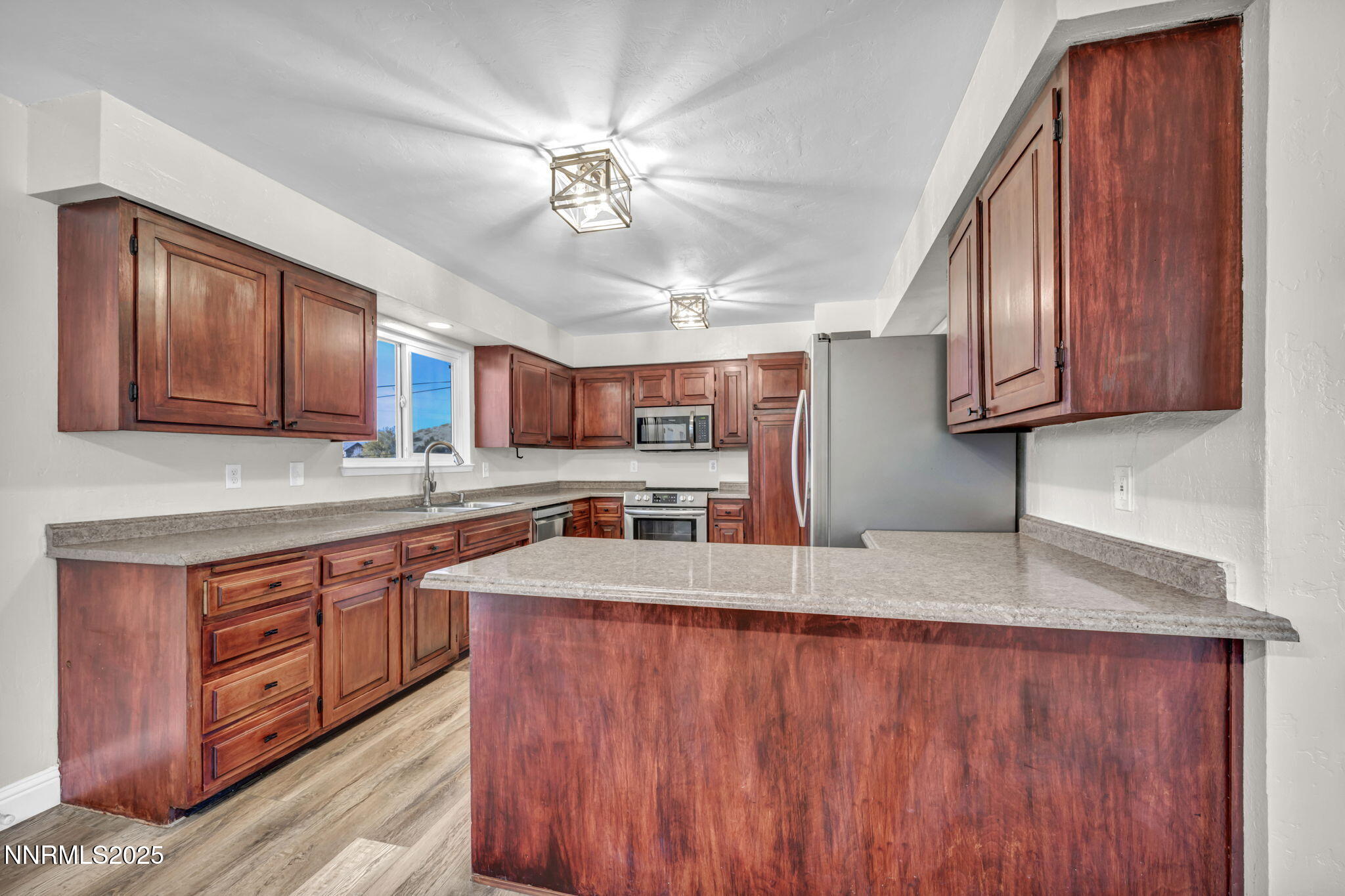 14595 Chamy Drive Reno, NV 89521 - Photo 25 of 66 a kitchen with stainless steel appliances granite countertop wooden cabinets a sink and dishwasher