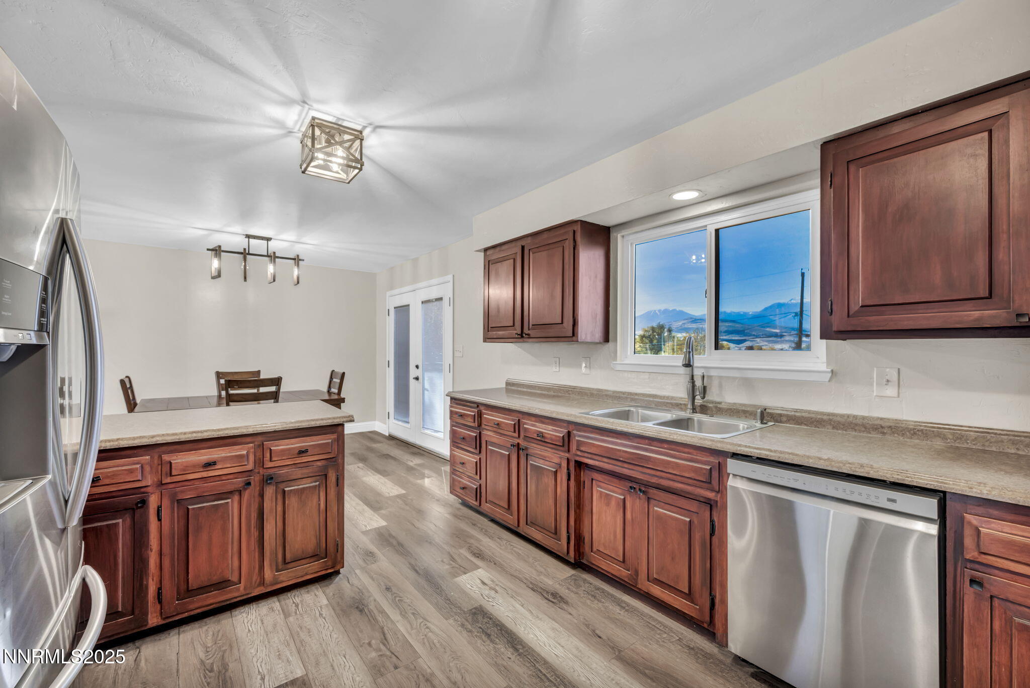 14595 Chamy Drive Reno, NV 89521 - Photo 26 of 66 a kitchen with stainless steel appliances granite countertop wooden cabinets a stove a sink and dishwasher