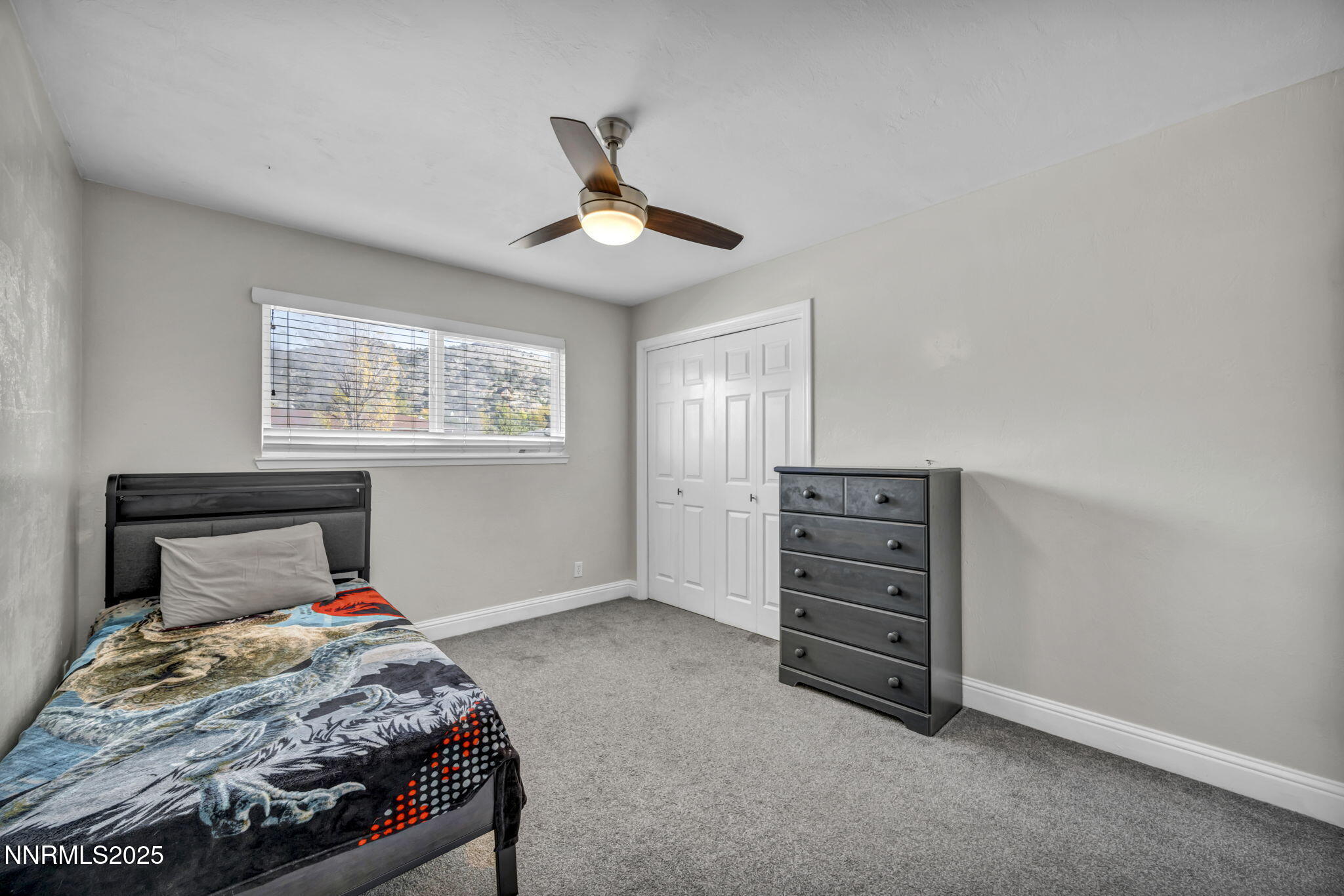 14595 Chamy Drive Reno, NV 89521 - Photo 30 of 66 a bedroom with a bed and a ceiling fan