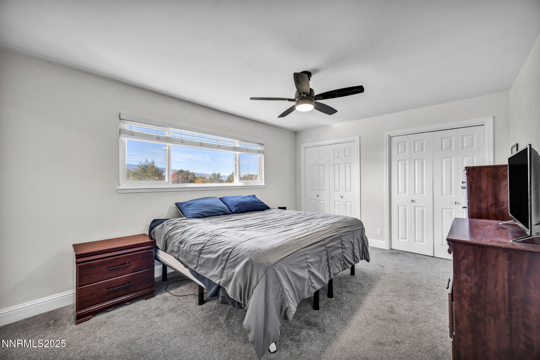 14595 Chamy Drive Reno, NV 89521 - Photo 32 of 66 a bedroom with a bed and a flat screen tv