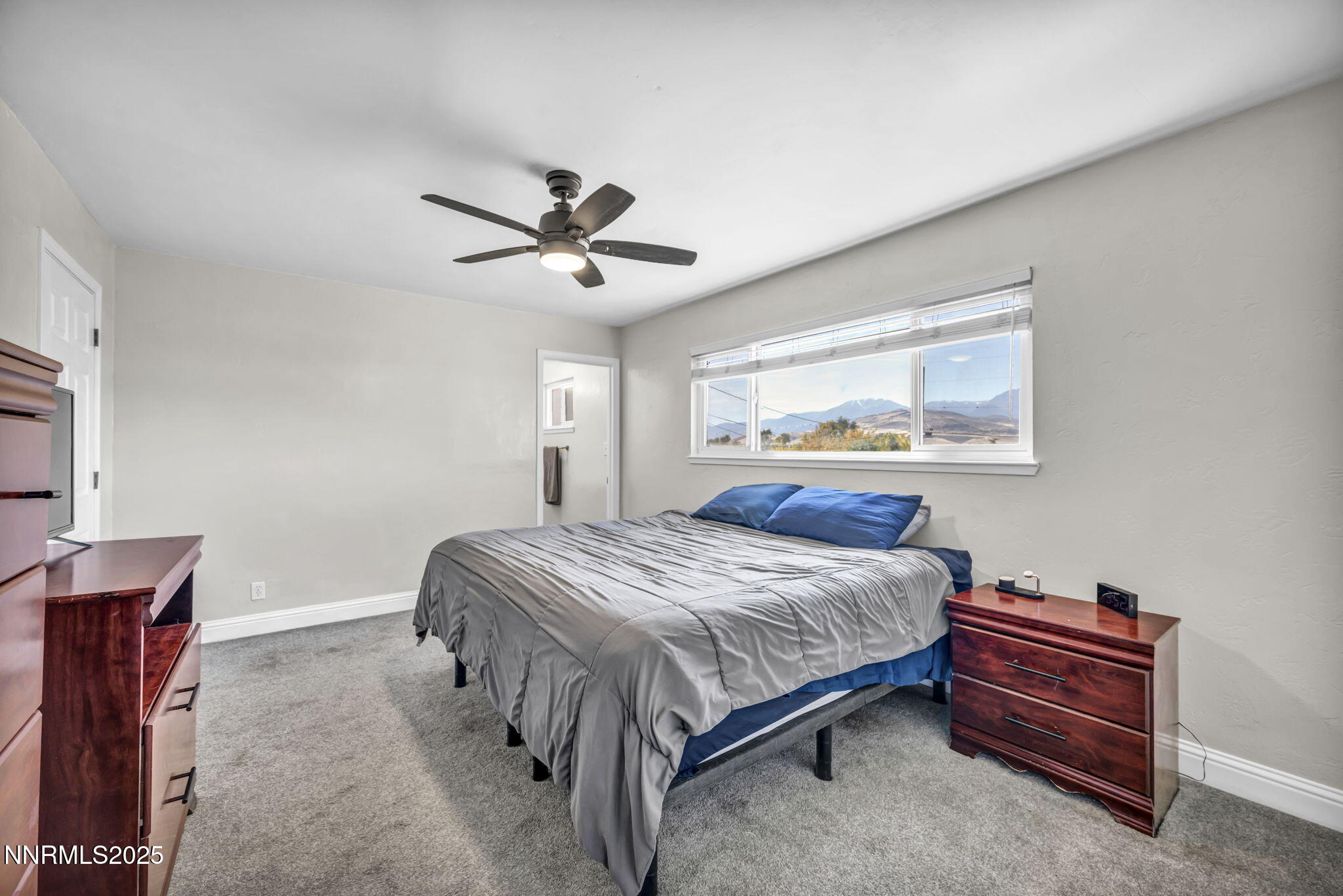 14595 Chamy Drive Reno, NV 89521 - Photo 33 of 66 a bedroom with a bed and a chandelier