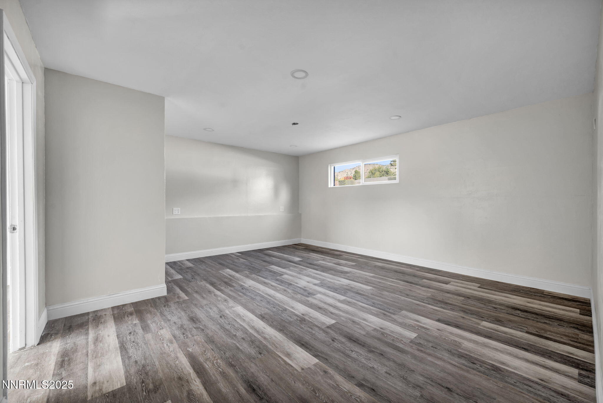 14595 Chamy Drive Reno, NV 89521 - Photo 39 of 66 a view of an empty room with wooden floor and a window