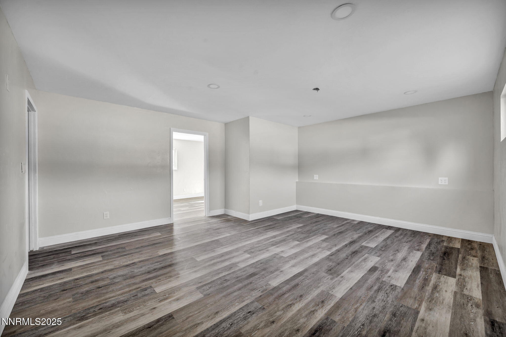 14595 Chamy Drive Reno, NV 89521 - Photo 40 of 66 a view of an empty room with wooden floor