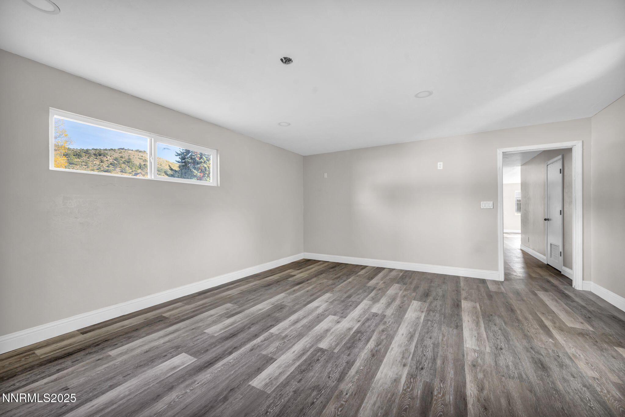 14595 Chamy Drive Reno, NV 89521 - Photo 42 of 66 a view of an empty room with wooden floor