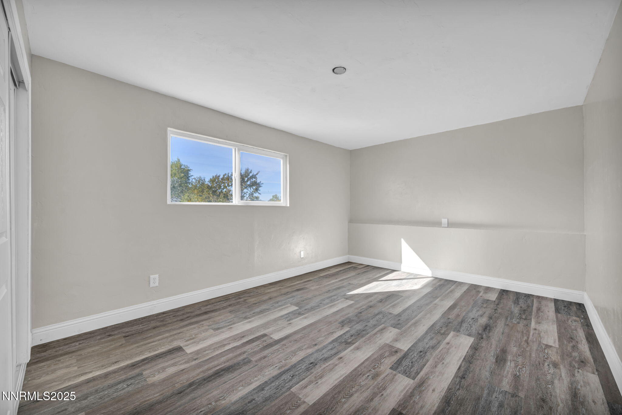 14595 Chamy Drive Reno, NV 89521 - Photo 43 of 66 a view of empty room with wooden floor