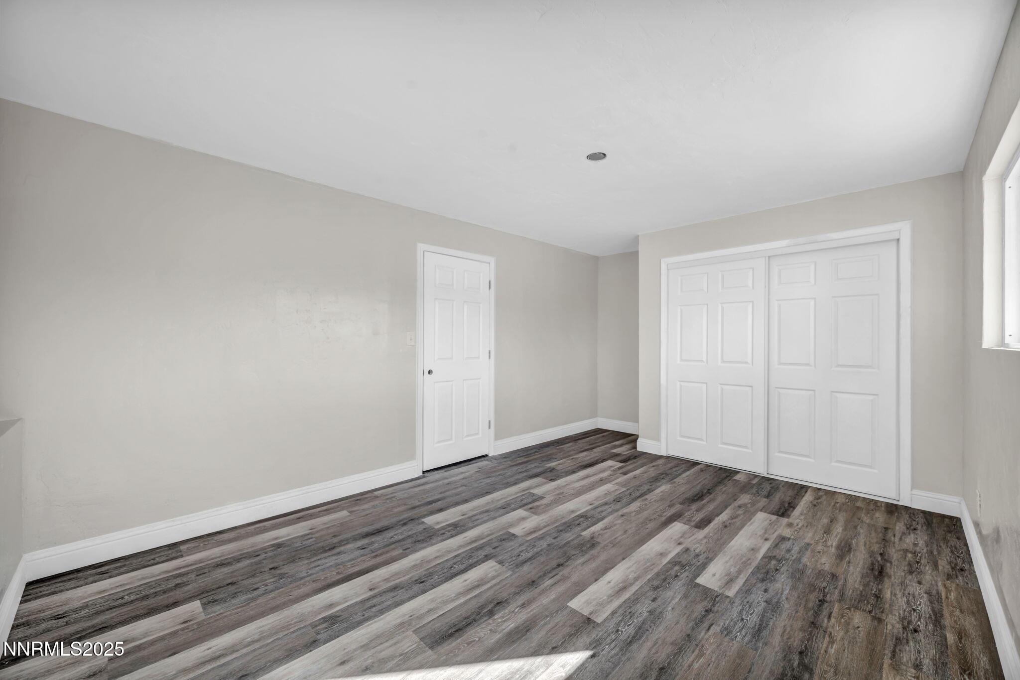 14595 Chamy Drive Reno, NV 89521 - Photo 44 of 66 a view of an empty room with wooden floor